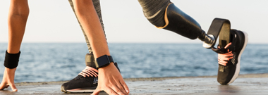 Woman with silicone prosthetic leg prepares to run
