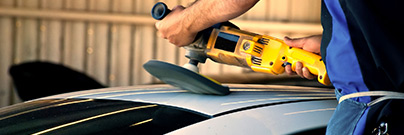 Man polishing roof of car