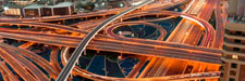 illuminated highway with multilevel intersections in a megapolis at night